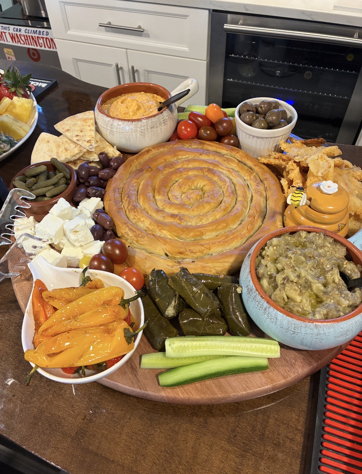 Mediterranean platter with spanakopita, hummus, baba ganoush, dolmas, feta, olives and warm pita