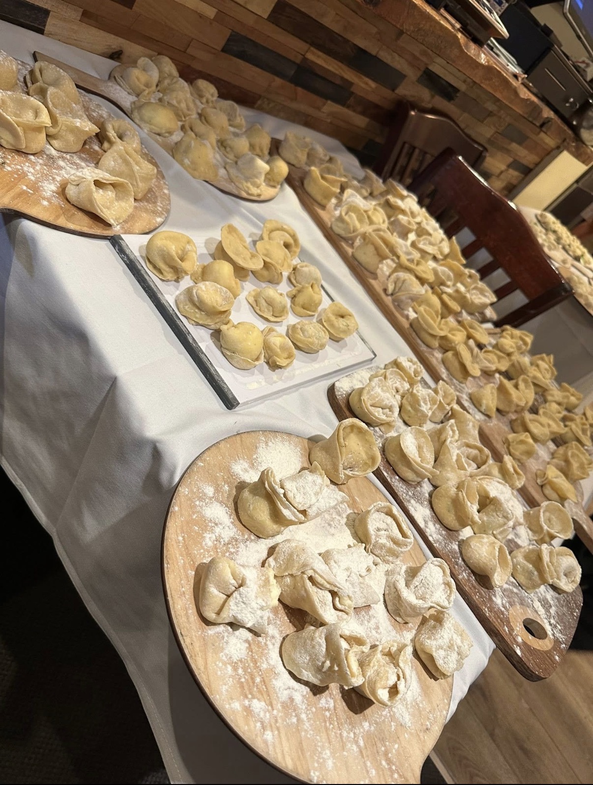 Boards of freshly made tortellini dusted with flour
